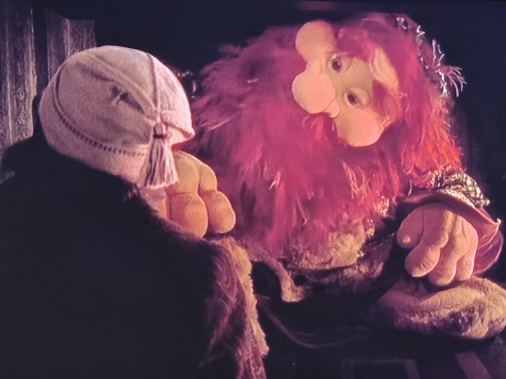 The Ghost of Christmas Present greets Scrooge and invites him to "Know me better man!"